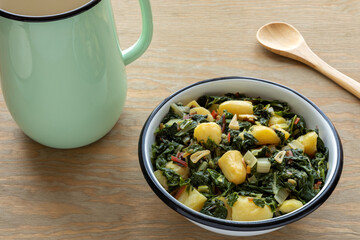 Potatoes with swiss chard leaves. South Croatian Blitva dish made with boiled potatoes, swiss chard, garlic and olive oil. - obrazy, fototapety, plakaty
