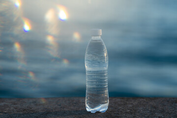 a bottle of clean drinking water on the pier on a sunny summer evening