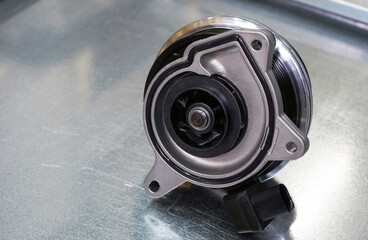 Brand new original high quality cooling system pump of a modern car. Selected focus.