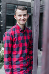 young handsome guy in a red checkered shirt