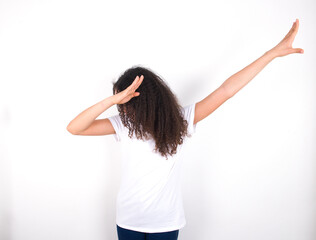 Photo of funky Teenager girl with afro hairstyle wearing white T-shirt over white wall  show disco...