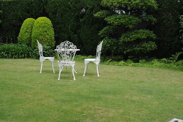 white chairs and table in the garden