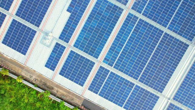 Top view of a solar power station on building roof, Renewable green energy. Clean energy industry in Nonthaburi, Thailand. drone footage. 4k
