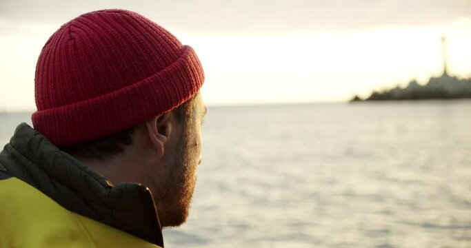 Portrait of a smiling sailor sailing on a boat at sunset