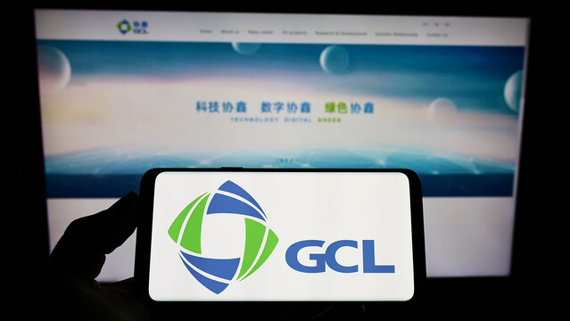 Stuttgart, Germany - 01-30-2022: Person holding smartphone with logo of energy company GCL-Poly Energy Holdings Limited on screen in front of website. Focus on phone display.