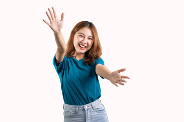 Portrait of an Asian woman smiling and extending her hand to present something with hands gesturing, isolated copy space on white background.