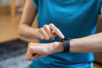 Relieve stress, relax muscles, practice breathing, exercise, meditate. Women exercise using smart watch to record exercise data.