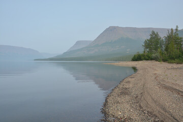 A mountain lake in a misty haze.