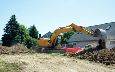 Construction Backhoe Dumping Excavated Dirt 