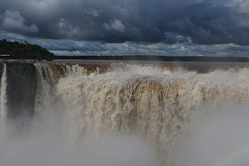 The photo shows a stunning view from the top of the Iguazu Falls — a complex of 275 waterfalls on the Iguazu River, located on the border of Brazil and Argentina