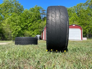 Tire in field with wildflowers