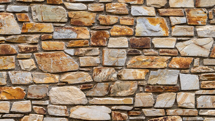 Nice colorful stone wall in beige, orange tones, close up, background