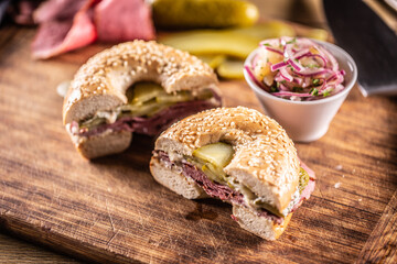 Bagel filled with juicy beef pastrami together with pickles