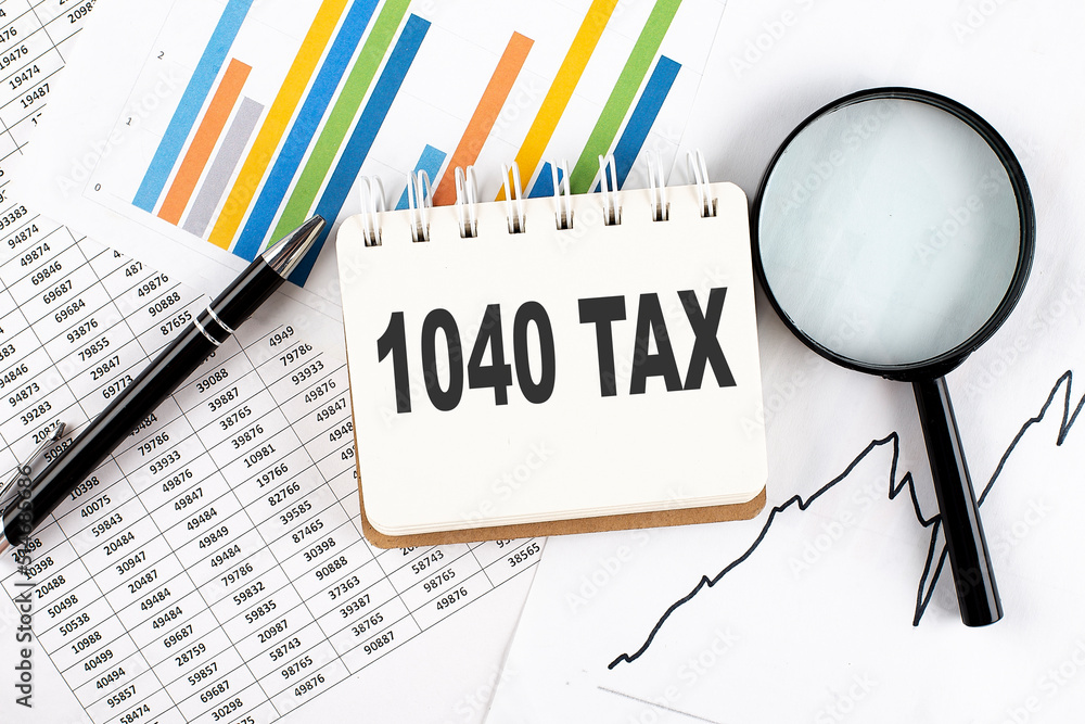 Poster 1040 tax text on notebook on the graph background with pen and magnifier