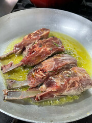 carré, made from roasted and fried lamb with mashed potatoes in pesto sauce, made in fancy restaurants, inside the kitchen, cooking the meat