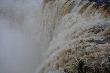The photo shows a stunning view from the top of the Iguazu Falls — a complex of 275 waterfalls on the Iguazu River, located on the border of Brazil and Argentina