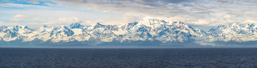 Fototapeta na wymiar Panorama of mountains and Mount Fairweather by Glacier Bay National Park in Alaska