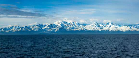 Panorama of mountains and Mount Fairweather by Glacier Bay National Park in Alaska