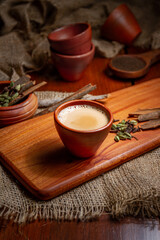Coffee cups milk beans and ground coffee in jar on wooden background high quality photo