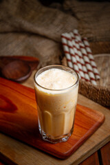 Coffee cups milk beans and ground coffee in jar on wooden background high quality photo