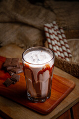 Coffee cups milk beans and ground coffee in jar on wooden background high quality photo