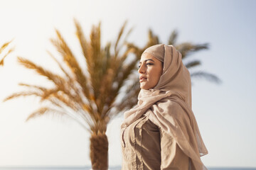Modern Muslim woman at balcony with sun light and thinking