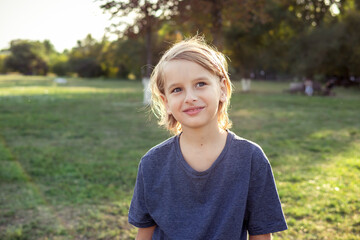 Teenger blonde boy outdoor park lifestyle portrait