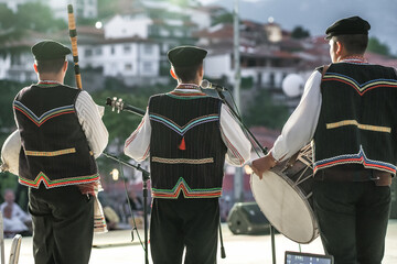 Unidentified Macedonian musicians in traditional costumes perform at folk music festival in Northern Macedonia. - obrazy, fototapety, plakaty