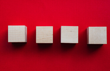 Four wooden cubes on a red background, mocap