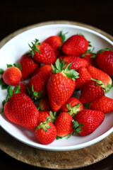 Fresh ripe strawberries in a bowl. Strawberry season.