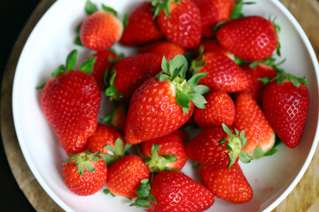 Fresh ripe strawberries in a bowl. Strawberry season.