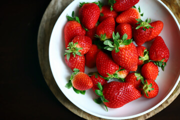 Fresh ripe strawberries in a bowl. Strawberry season.