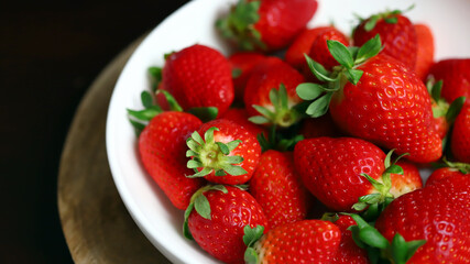 Fresh ripe strawberries in a bowl. Strawberry season.
