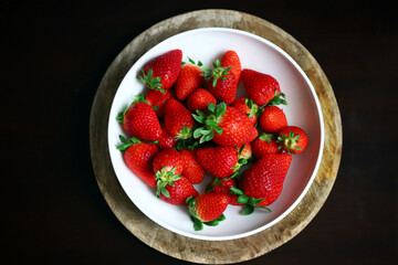 Fresh ripe strawberries in a bowl. Strawberry season.