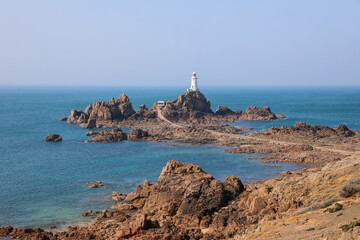 Fototapeta na wymiar View of the La Corbiere lighthouse at low tide in Jersey