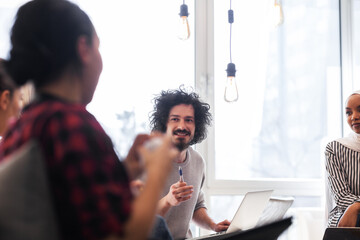 Young successful people brainstorming at a creative meeting.