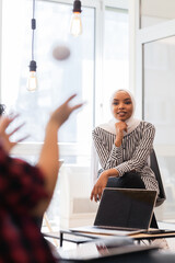 Young successful people brainstorming at a creative meeting.