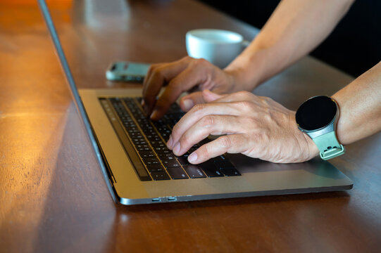 Man using laptop with coffee cup , searching web, browsing information, having workplace at home / soft focus picture / Vintage concept
