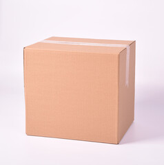 brown cardboard box sealed with adhesive tape on a white background