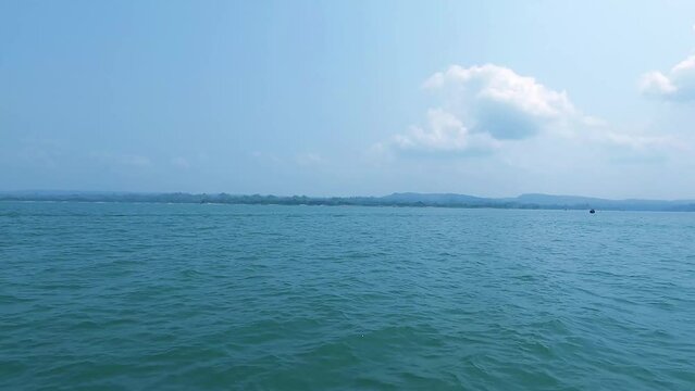 Beautiful Kaptai Lake in Rangamati Bangladesh. Wooden boats on the water, surrounded by mountains.	