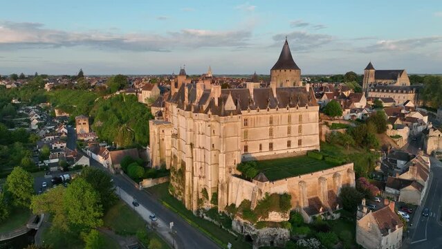 Sunset aerial view of Chateaudun  castle in Eure-et-Loire in France with imposing circular keep, Gothic high chapel, Renaissance residential palace and bell tower perched on a limestone outcrop