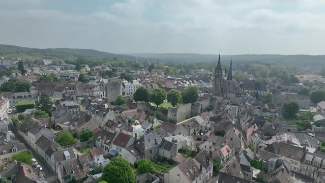 Aerial video view of medieval Dourdan castle, square shape with eight towers including a stand alone circular donjon with drawbridge over the moat in Essone ile de France