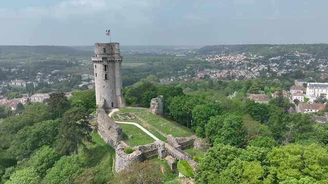 Aerial view of medieval ruined Montlh&eacute;ry castle controlling the Paris - Orleans road with prominent keep towering over the hill in Central France