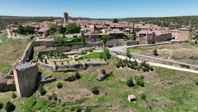 Panning video around the medieval picture perfect town of Pedraza near Segovia in Spain with city gate, towers, bastions, Gothic church popular tourist destination