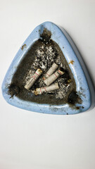 Cigarette butts in ashtray on white background
