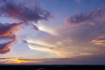 Dramatic orange sunset with the sun peeking through the clouds an gorgeous panorama view