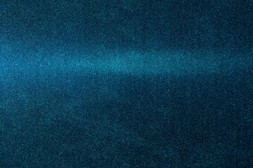On a dark blue grungy background, a gradient blue horizontal beam of light