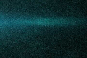On a dark turquoise grungy background, a gradient turquoise horizontal beam of light