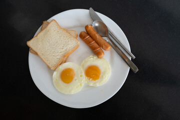 Breakfast arranged on a plate, paired with spoons and sparring