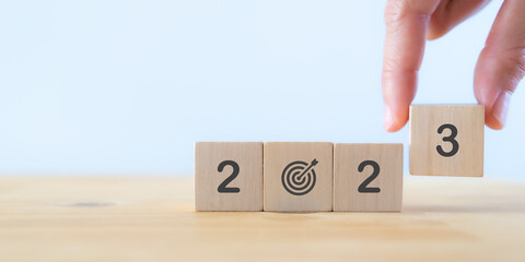 2023 goals of business or life. Team building. Wooden cubes with 2023 and goal icon. Starting to...